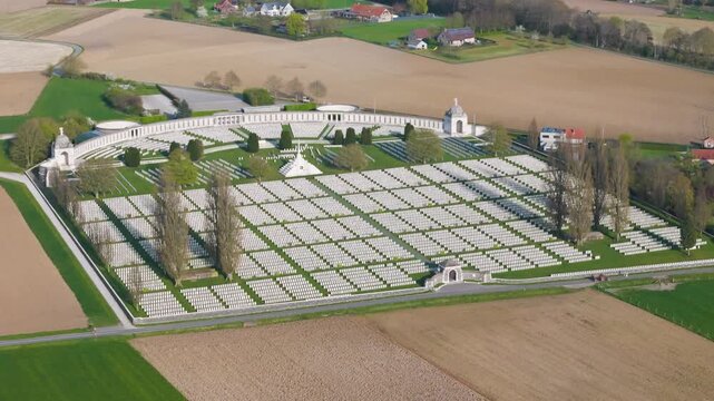 world war i military cemetery tyne cot aerial view uniform white headstones rows curved memorial wall domed pavilions stone archway farmland zonnebeke belgium flanders passchendaele 1917 remembrance