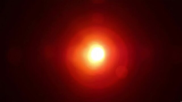 Abstract blurred red light bokeh on a dark black background