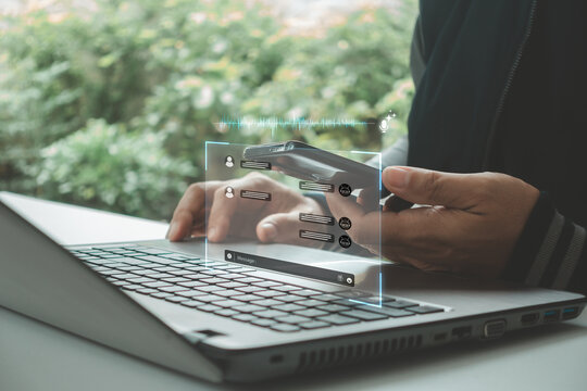 Professional using smartphone and laptop with digital chat interface, artificial intelligence, online communication, virtual assistant, customer service, remote work, modern technology solutions.