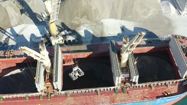 Aerial view of a bulk-carrier ship downloading in the Mediterranean Spanish port of Alicante.