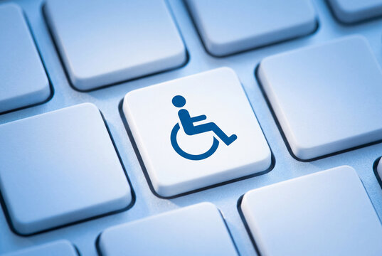 White computer keyboard button featuring a blue wheelchair symbol indicating digital accessibility