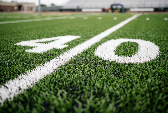 Close up of the forty yard line marker on a green artificial turf football field