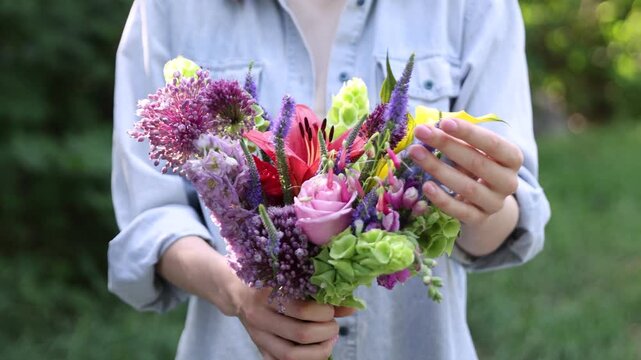 Woman with bouquet of beautiful summer flowers outdoors, closeup