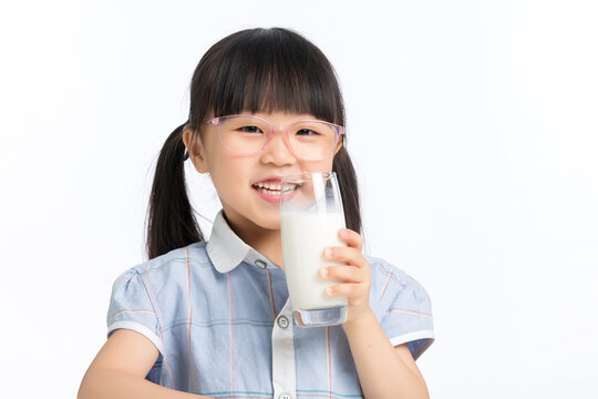 Happy child holding a glass of milk for healthy growth