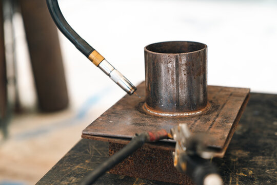 Metal welding torch pipe steel fabrication workshop joint heat industrial