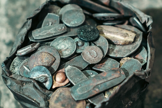 Scrap metal old coin antique button patina copper collection in worn pouch with corroded relic rusted object vintage texture historical artifact