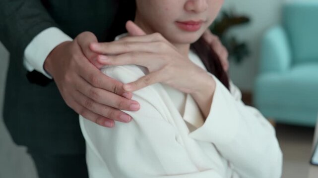business man sexually harassed a female colleague by touch her shoulder. Sexual harassment in office. Women feel anxious and stressed from being harassed. molest, assault, inappropriate