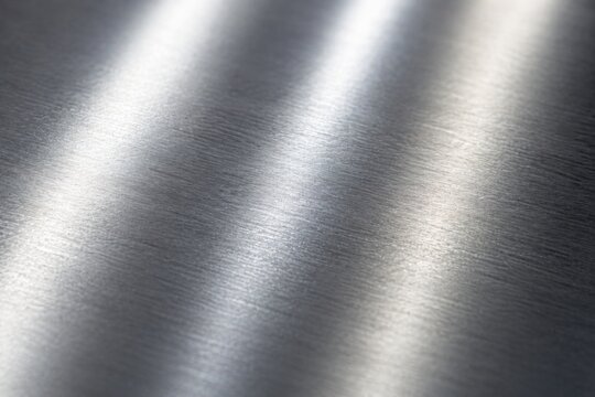 Brushed stainless steel metallic surface texture with light