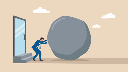 A businessman in a blue suit pushing a large, heavy gray boulder toward a doorway, representing hard work, persistence, and business strategy concept © Sharmin