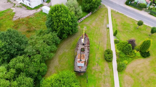 Aerial Drone View Of Pavilosta Town Center And The Saka River In Latvia. The Historic Ship Dole Rests Along The Waterfront, Surrounded By Charming Architecture And Beautiful Summer Scenery.