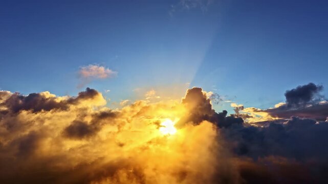Golden sunrise light streams through dramatic clouds in a vibrant sky scene