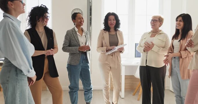 Women team meeting for coaching training discussion. A workshop in an office shows leadership and communication as colleagues collaborate and plan. Concept of teamwork and female leadership.
