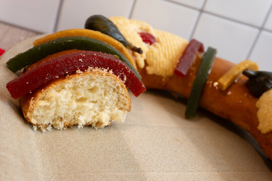 Part of "Rosca de Reyes" or Epiphany bread, cut. Highlights colorful embellishments