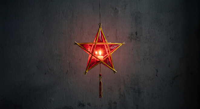 Traditional Vietnamese red star shaped paper lantern glowing with candle light for Mid-Autumn Festival