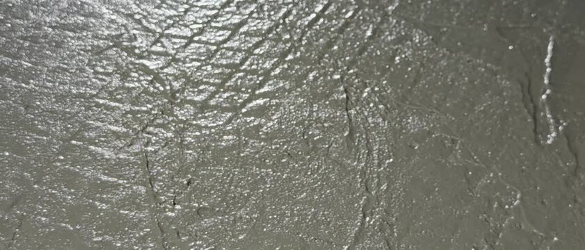High resolution wet concrete plaster texture spread on surface. Ideal background for construction, architecture, building materials, industrial projects, and raw material concept design