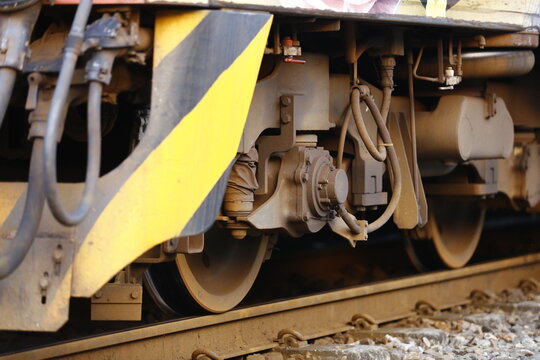 A close up view of train wheels and bogie.