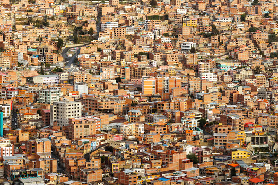 Dense brick houses on a steep hillside in La Paz, Bolivia
