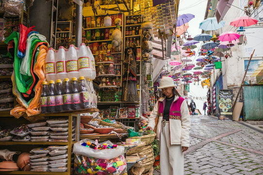 Asian woman at traditional stall at the Witches Market in La Paz, Bolivia