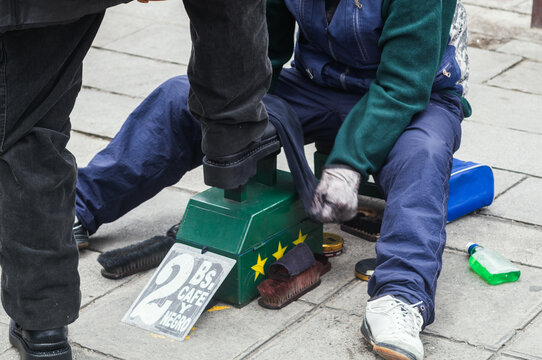Shoe shiner polishing shoes on a La Paz street, Bolivia