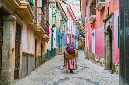 Cholita walking along a colonial street in La Paz, Bolivia