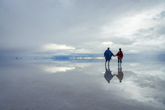 Couple holding hands on the Salar de Uyuni, Bolivia