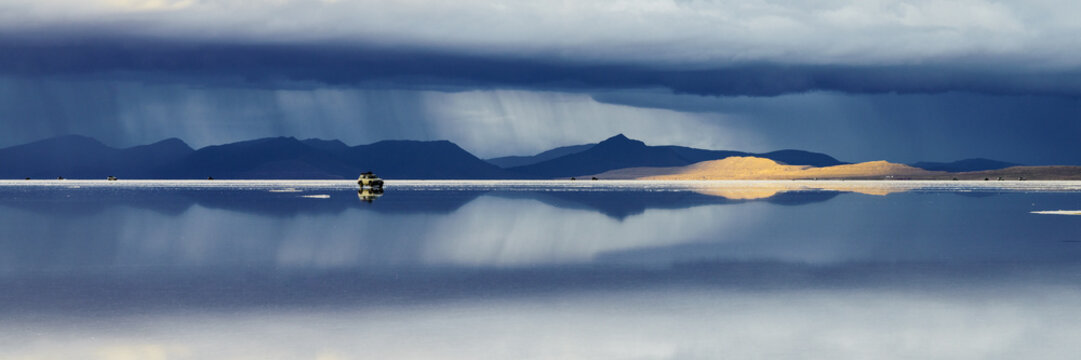 Storm clouds over the mountains beyond the Salar de Uyuni, Bolivia
