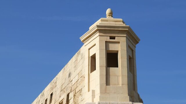 vedette sentry turret fort st elmo corner bastion detail carved limestone finial pointed roof clear blue sky valletta malta coastal fortification military architecture 16th century star fort