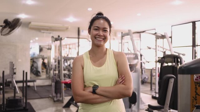 Hyrox race indoor looking at camera smile relax sport active asia people young Gen Z woman self care club. Girl power cross full core body cardio class muscle weight loss anti aging modern gym living