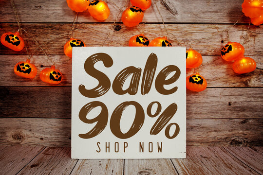 Halloween Sale 90% text with Halloween decoration on wooden background