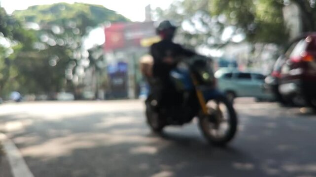 Blurred Bokeh City Street Traffic with Passing Cars and Motorcycles Background
