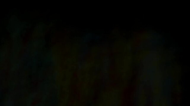 Colorful light trails rise against a pitch black background creating an abstract texture.