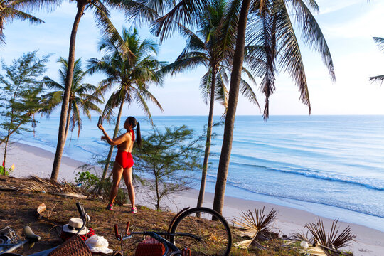 Woman with red swimsuit relax on beach