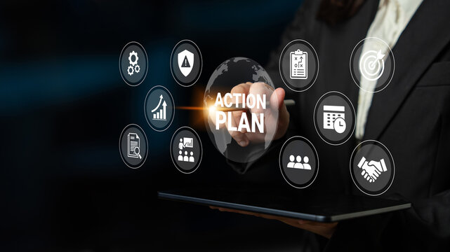 A business professional develops a digital action plan, utilizing a tablet and innovative icons to symbolize strategic goals and productivity in a contemporary environment. Ledger