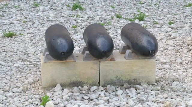 cast iron cannonballs fort st elmo wooden display blocks gravel yard museum exhibit valletta malta historic weaponry siege ammunition artifact coastal defense artillery display collection