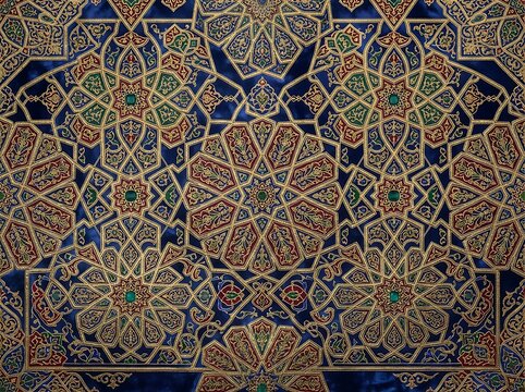 Complex tessellated islamic geometric patterns in gold red and green against deep blue velvet showcasing detailed arabesque motifs.