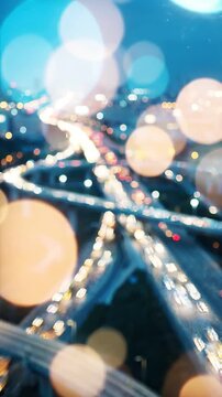Aerial View of a City Overpass at Night Captured in Blurred Perspective, Highlighting the Flow of Traffic and City Lights Against a Twilight Sky