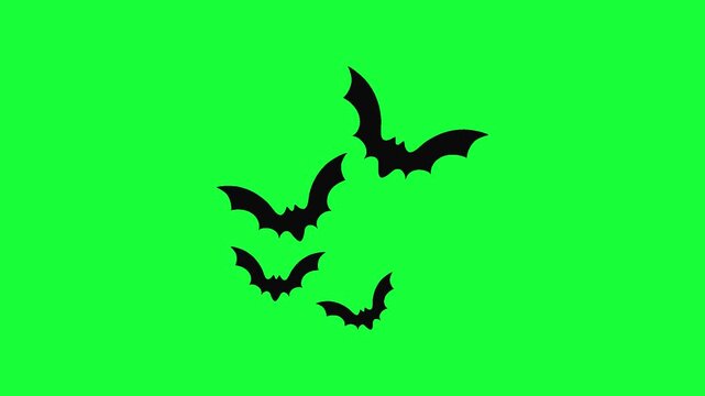 Black silhouettes of bats flying together isolated on a bright green background
