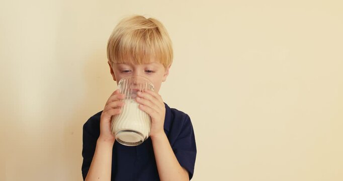 Little boy drinking a glass of milk