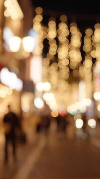 A Night Scene Filled with Glowing Lights and Silhouetted Figures: Capturing the Magical Atmosphere of a Vibrant City Street Decorated for the Night
