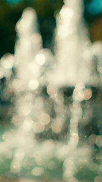 Captivating Water Fountain Close-Up: An Artistic Representation of Fluidity and Motion Through Dazzling Bokeh and Vibrant Light Reflection