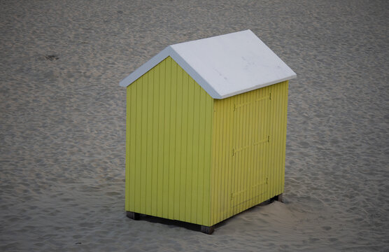 Yellow wooden beach hut on sandy beach in Berck-sur-Mer France