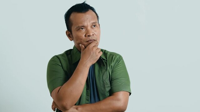 Portrait of pensive inspired hesitate Asian man thinking idea creative, think dreaming and doubtful unsure considering solution decide, thoughtful contemplating for ads.