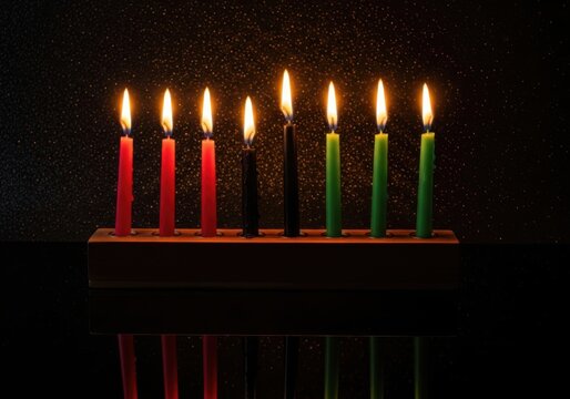Seven lit candles in a wooden holder against a dark background