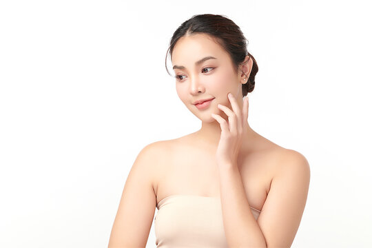 A beautiful young Asian woman with clean, fresh skin against a white background. Skincare, facial treatment, cosmetology, beauty, and spa. An elegant portrait of an Asian woman.