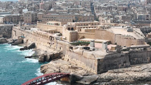 fort st elmo aerial view city skyline backdrop valletta malta overcast sky rough sea grand harbour coastal fortification peninsula star fort layout internationally recognized heritage site