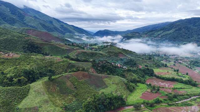 Aerial view from drone of the rural village in the mountains on foggy morning, Nan province, Thailand