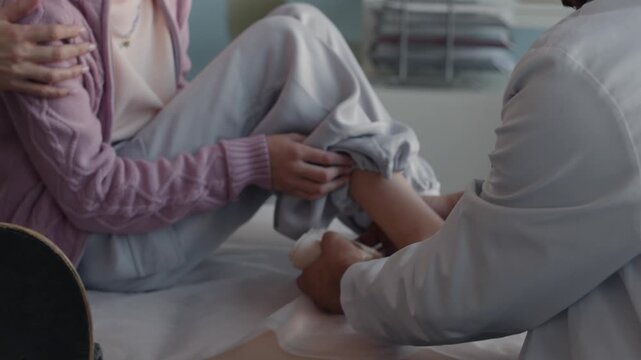 doctor in hospital checking legs of patient broken bones bandage 
