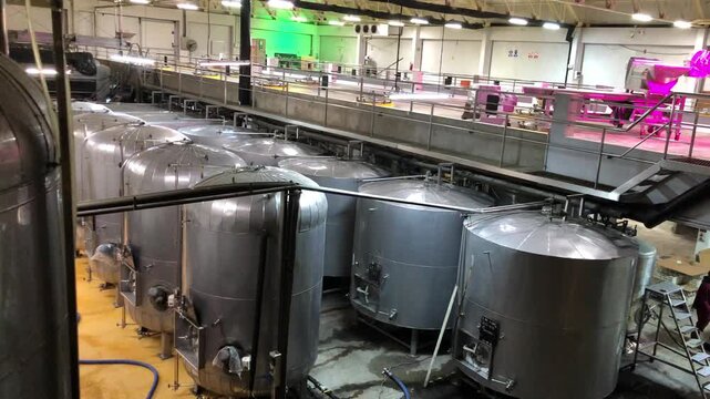 Large steel fermentation tanks in a winery facility in ica, peru