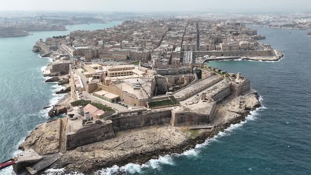 fort st elmo aerial view tigne skyline distant valletta malta overcast sky rough sea grand harbour coastal fortification peninsula star fort layout internationally recognized heritage site