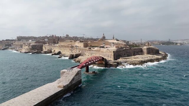 fort st elmo red breakwater bridge aerial view valletta malta overcast sky rough sea grand harbour coastal fortification peninsula star fort layout internationally recognized heritage site